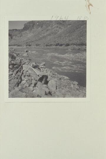 Up to head of Rapid 16.  The flat rock out from the left shore is the one which trapped the boat of the Best Expedition