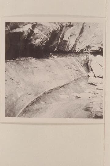 Red stains on rock at spring in Black Water Creek; North side of Navajo Mountain.  Black Water Cave